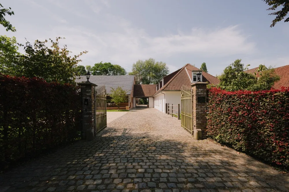 Een klassiek ijzeren hek sluit het domein van De Baian af van de Krauwerstraat. Een klassiek ijzeren hek sluit het domein van De Baian af van de Krauwerstraat.